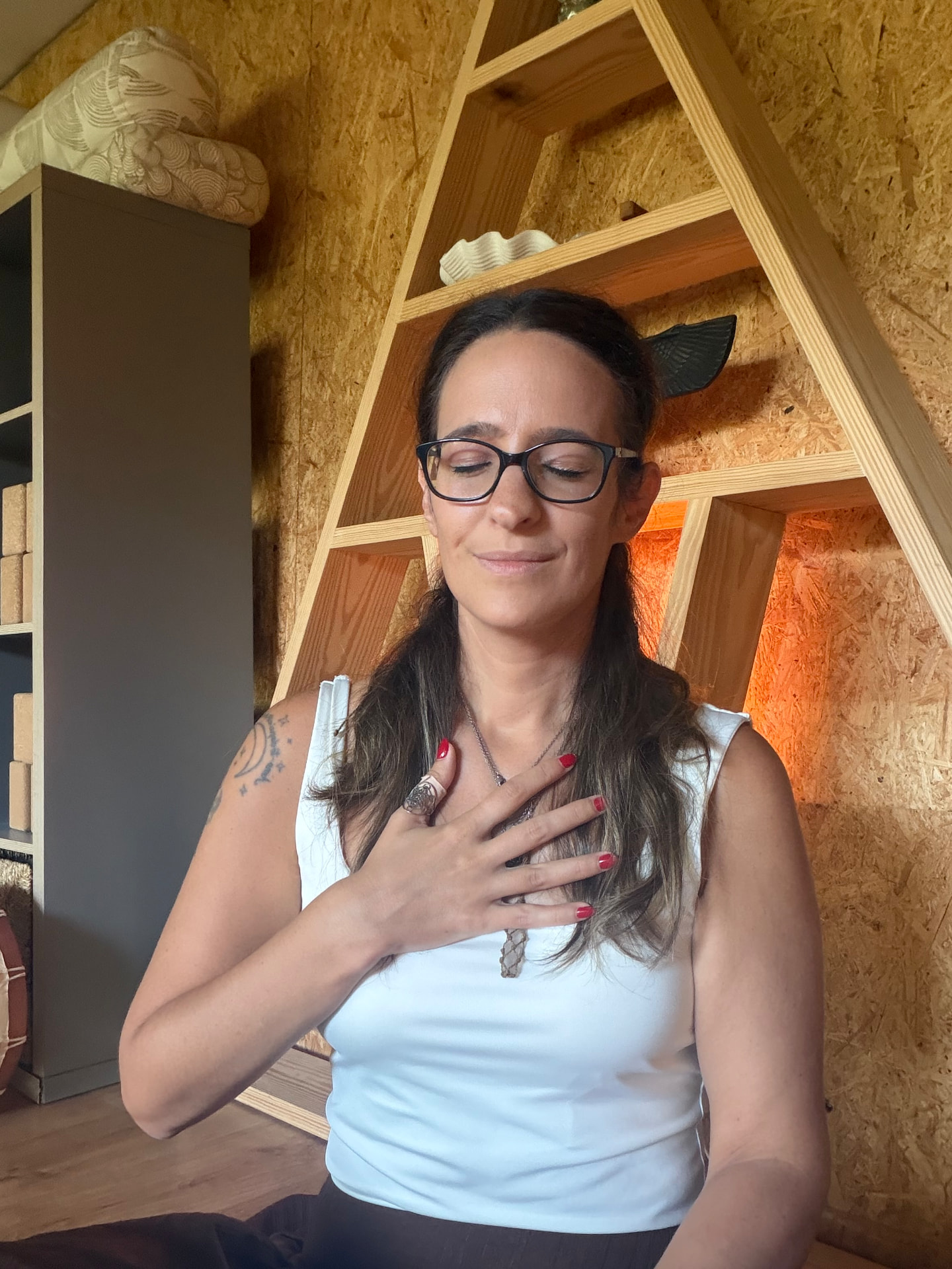 Paula de olhos fechados, com a mão sobre o peito